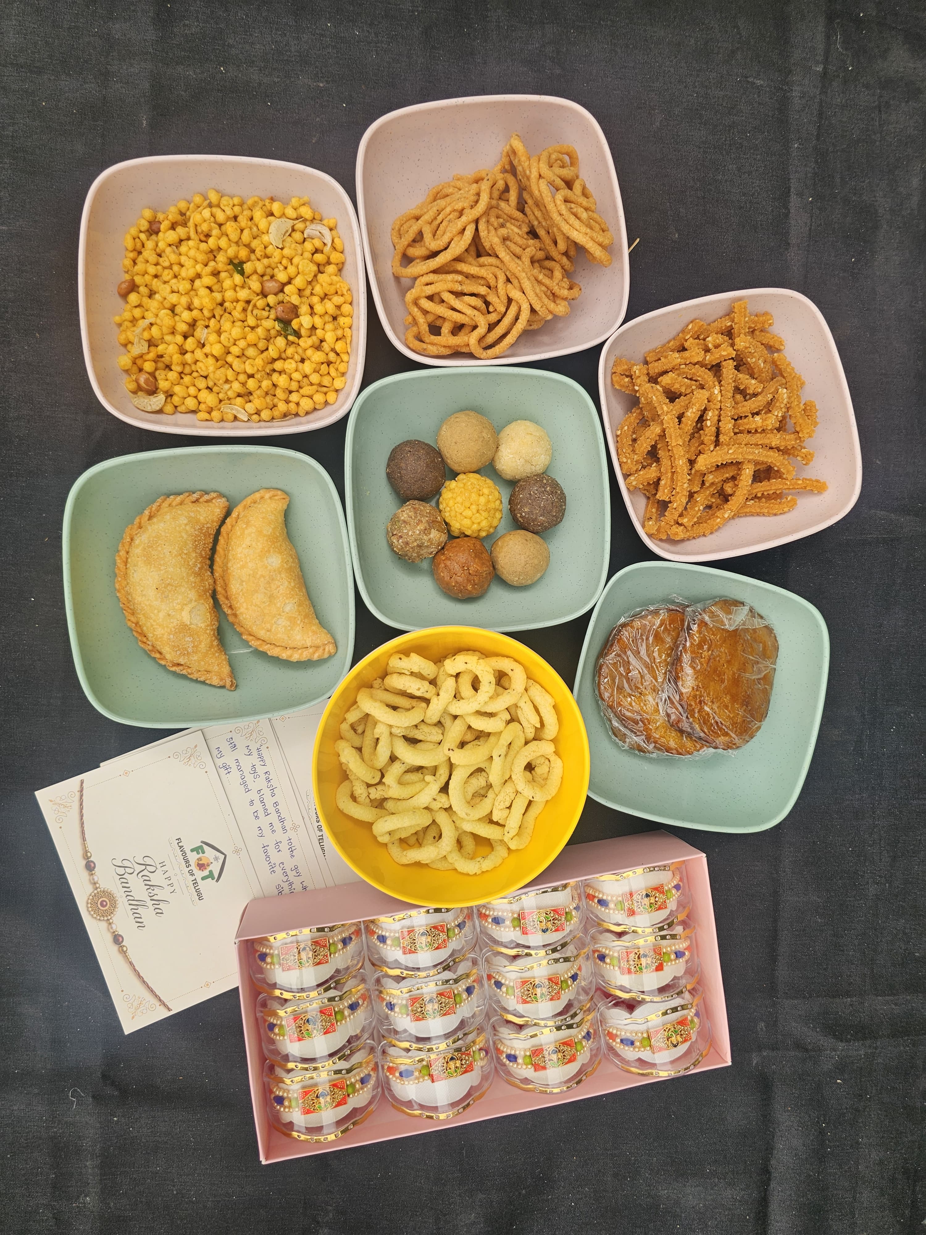 "Rakhi Mega Combo hamper with handmade laddus and festive snacks"
"8 assorted traditional laddus in handmade leaf box"
"Premium rakhi with kumkum and puja essentials"
"Beautifully packaged Rakhi gift hamper ready to send"
"Festive snacks and handmade sweets Rakhi combo"